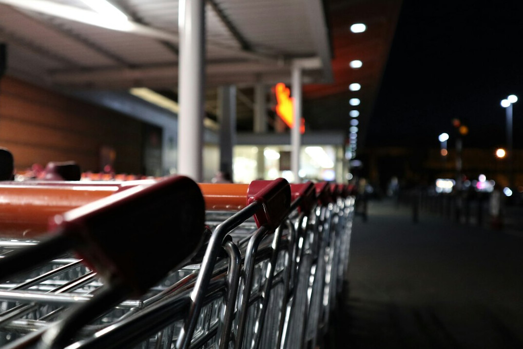 night supermarket aisle with shoppers